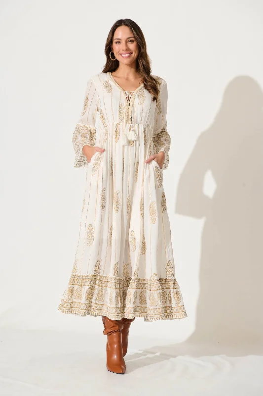 Sheer maxi dresses with lace overlays for a romantic touchEllie Maxi Dress In White With Gold Print