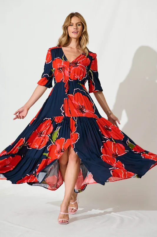 Maxi dresses with tassel accents for a fun and lively touchEmilia Maxi Dress In Navy With Red Floral